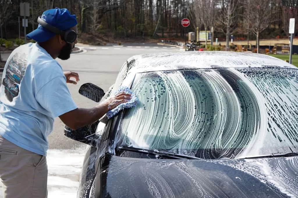 Ehudy Montas washing BMW at Supreme Bucks Detailing in Sugar Hill GA